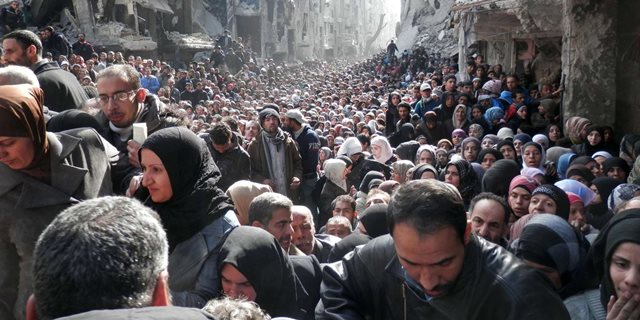 TOPSHOTS A handout picture released by the United Nation Relief and Works Agency (UNRWA) on February 26, 2014 shows residents of Syria's besieged Yarmuk Palestinian refugee camp, south of Damascus, crowding a destroyed street during a food distribution led the UN agency, on January 31, 2014. AFP PHOTO/HO/UNRWA === RESTRICTED TO EDITORIAL USE - MANDATORY CREDIT "AFP PHOTO / HO / UNRWA" - NO MARKETING NO ADVERTISING CAMPAIGNS - DISTRIBUTED AS A SERVICE TO CLIENTS ===